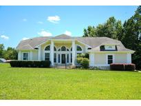 Inviting home with an arched window entryway, manicured lawn and verdant bushes at 6101 Valentine St, Zebulon, NC 27597