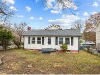 White house with gray roof, small front yard, and steps leading to the front door at 826 Carter Ave, Durham, NC 27703