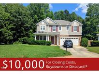 Charming two-story home featuring a well-manicured lawn and attached two-car garage at 101 Clardona Way, Holly Springs, NC 27540