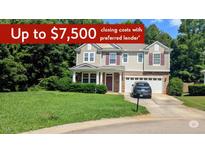 Charming two-story home with a manicured lawn, attached garage, and mature trees, offering a welcoming curb appeal at 101 Clardona Way, Holly Springs, NC 27540