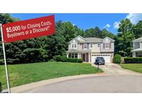 Charming two-story home with a well-manicured lawn, two-car garage, and a welcoming front entrance at 101 Clardona Way, Holly Springs, NC 27540