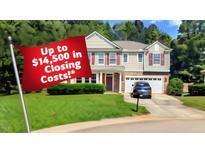 Charming two-story home with a manicured lawn and a promotion of up to $14,500 in closing costs at 101 Clardona Way, Holly Springs, NC 27540