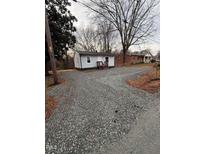 Charming, one-story home with rock-covered yard and covered front porch at 1118 Jackson St, Burlington, NC 27217