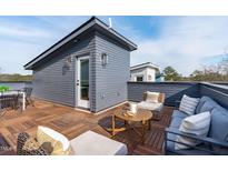 Inviting rooftop deck features stylish outdoor furniture and charming wood flooring for relaxation at 612 Rocky Knob Ct, Raleigh, NC 27601