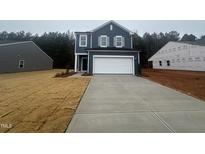 Two-story house with gray siding, white garage door, and a partially grassy yard at 6856 Galloway Dr, Middlesex, NC 27557