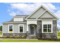 Charming home exterior featuring stone accents, and a well-manicured lawn at 261 Kissington Way, Benson, NC 27504