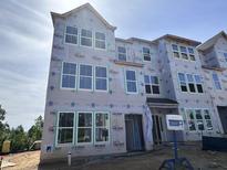 New construction home featuring large windows and modern design elements at 303 Chesapeake Cmns St # 99, Garner, NC 27529
