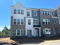New construction townhome featuring brick facade, multiple windows, and a modern design at 303 Chesapeake Commons St # 99, Garner, NC 27529