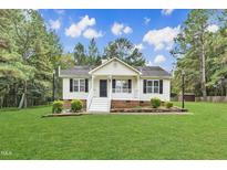 Charming one-story home with a well-manicured lawn, inviting entrance, and classic curb appeal at 308 Deep Creek Dr, Clayton, NC 27520