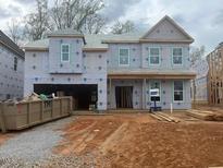 Under-construction two-story home featuring a two-car garage and a covered entry, awaiting its finishing touches at 219 Augusta Pond Way # 157, Raleigh, NC 27603