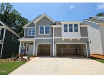 New construction home with grey siding, a two-car garage, and landscaping at 223 Augusta Pond Way # 158, Raleigh, NC 27603