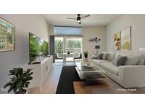 Staged living room with modern furniture, large windows, and neutral color palette at 600 S Duke St # 26, Durham, NC 27701