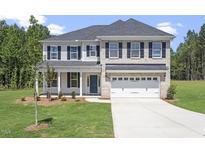 Beautiful two-story home featuring a brick and vinyl facade, lush lawn, and a two car garage at 55 New Liberty Dr, Youngsville, NC 27596