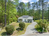 Charming single-story home featuring a landscaped front yard and a winding driveway at 1408 Ferrell Ct, Creedmoor, NC 27522