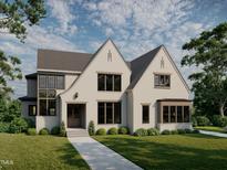 Stunning new construction home with a manicured lawn, large windows, and a modern design at 5101 Olde South Rd, Raleigh, NC 27606