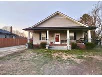 Charming home featuring a front porch with swing and landscaped yard at 102 W C St, Erwin, NC 28339
