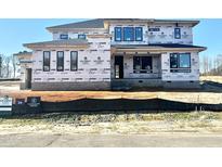 New two-story home with black window frames and a clean, modern design during the construction phase at 130 Broadleaf Ln, Louisburg, NC 27549