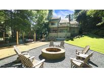 Inviting backyard featuring a fire pit, bocce ball court, and outdoor dining area at 2213 Weybridge Dr, Raleigh, NC 27615