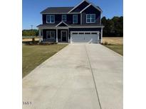 Charming navy two-story home with a spacious driveway and well-maintained front lawn at 23 Surles Landing Way, Benson, NC 27504