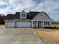 Charming single-story home featuring a three-car garage, stone accents, and a welcoming front porch at 48 Surles Landing Way, Benson, NC 27504