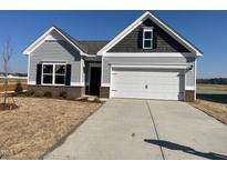 Charming single-Gathering home featuring gray siding, brick accents, and a two-car garage at 17 E Victory View Ter, Smithfield, NC 27577