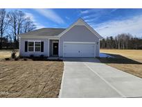 Charming single-story home featuring a attached garage and well-maintained lawn and landscaping at 87 Vili Dr, Broadway, NC 27505