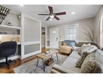 Cozy living room features a comfy couch, wood floors and built-in shelving at 909 E F St, Butner, NC 27509