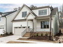 Charming two-story home featuring an attached garage and a welcoming brick staircase leading to the front porch at 108 Bearwallow Forest Way, Wendell, NC 27591