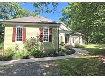 Charming home exterior features red shutters, a well-maintained lawn, and lovely landscaping at 109 Springwood Dr, Wake Forest, NC 27587
