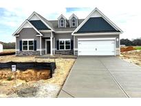 Charming single-Gathering home boasts a modern design, two-car garage, and professional landscaping at 260 Olivia Crossing Ct # 9, Four Oaks, NC 27524