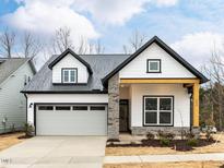 Charming home boasts a stylish blend of modern farmhouse design and a convenient attached garage at 443 Imagine Way, Pittsboro, NC 27312