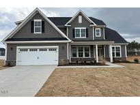 Charming two-story home with gray siding, a two-car garage, and a well-manicured lawn at 467 Ravensworth Dr, Garner, NC 27529