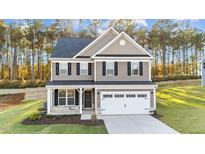 Two-story house with gray siding, white garage door, and landscaping at 505 Ravensworth Dr, Garner, NC 27529