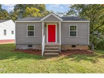 Gray house with red door, steps, and landscaping at 520 Avon Ave, Burlington, NC 27215
