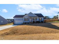 Ranch style home with attached garage and landscaped yard at 58 Northview Dr, Middlesex, NC 27557