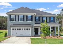 Charming two-story home with a two-car garage and inviting front porch at 60 Accord Dr, Youngsville, NC 27596