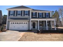 Charming two-story home featuring a two-car garage, covered front porch, and well-manicured lawn at 60 Accord Dr, Youngsville, NC 27596