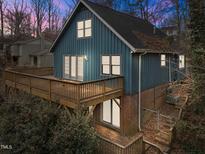 Two-story house with blue siding, large deck, and surrounding trees at 6708 Winding Trl, Raleigh, NC 27612
