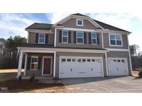 Two-story home with neutral siding, black shutters, and a three-car garage on a sunny day at 70 Accord Dr, Youngsville, NC 27596