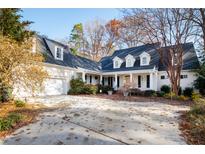 Two-story house with a large front yard, driveway, and attached garage at 7516 Wingfoot Dr, Raleigh, NC 27615