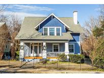 Charming blue two-story home with white trim and a wraparound porch at 807 E Edenton St, Raleigh, NC 27601