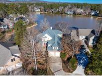 Stunning waterfront home with mature trees and a private driveway leading to a two car garage at 81002 Alexander, Chapel Hill, NC 27517