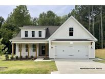 Two-story house with white siding, brown accents, and a two-car garage at 107 Pretty Run Branch Ln, Wendell, NC 27591