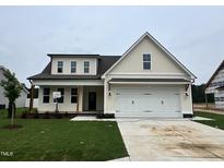 Charming two-story home with a large front yard and attached two-car garage at 107 Pretty Run Branch Ln, Wendell, NC 27591