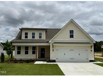 Charming two-story home featuring a two-car garage, front porch and neutral color palette at 107 Pretty Run Branch Ln, Wendell, NC 27591