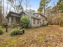 Rustic home with wood siding, large yard, and deck at 1115 Manco Dairy Rd, Pittsboro, NC 27312