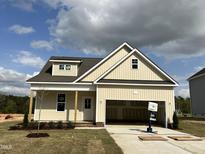 Charming single-story home with a front porch and attached two car garage at 137 Pretty Run Branch Ln, Wendell, NC 27591