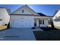 Charming one-story home with a two-car garage and landscaped front yard at 137 Pretty Run Branch Ln, Wendell, NC 27591