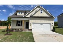 Charming single-Gathering home featuring a two-car garage, manicured lawn, and craftsman-style architecture at 137 Pretty Run Branch Ln, Wendell, NC 27591