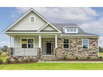 Charming home exterior features a stone facade, a welcoming porch, and lush landscaping at 292 Weddington Way, Benson, NC 27504